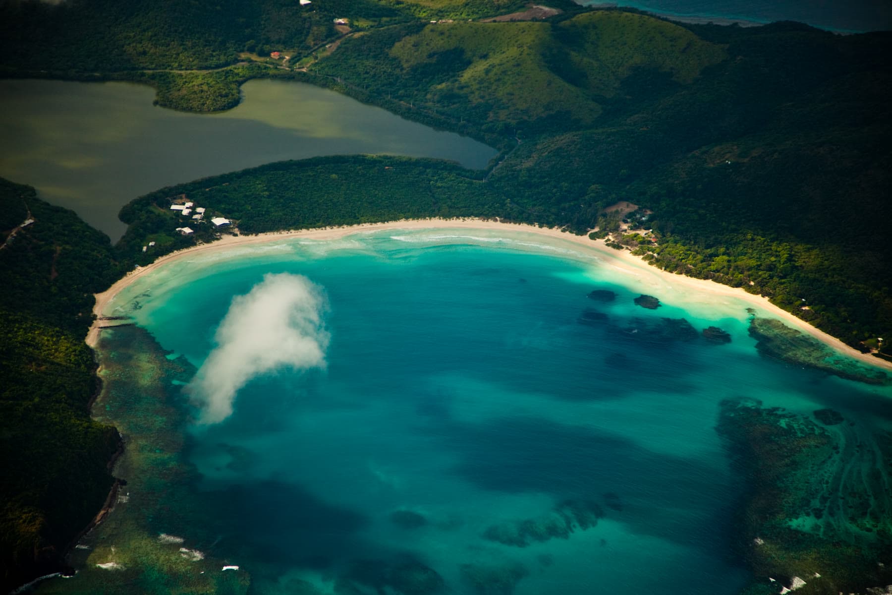 Flamenco Beach on Culebra, a horseshoe of white sand and turquoise water framed by green hills